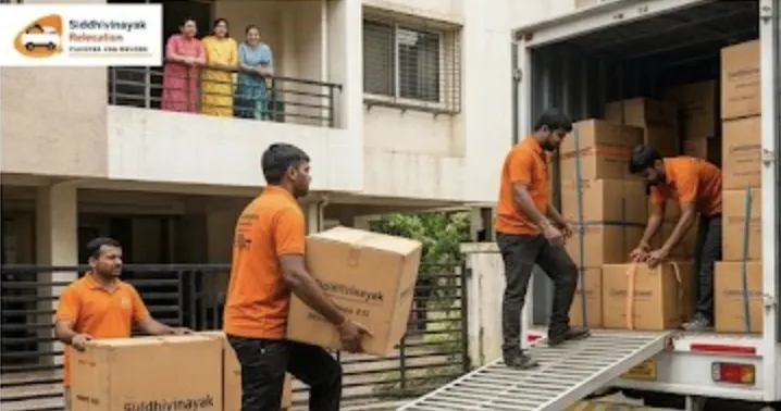 Home shifting team loading packed cartons into truck